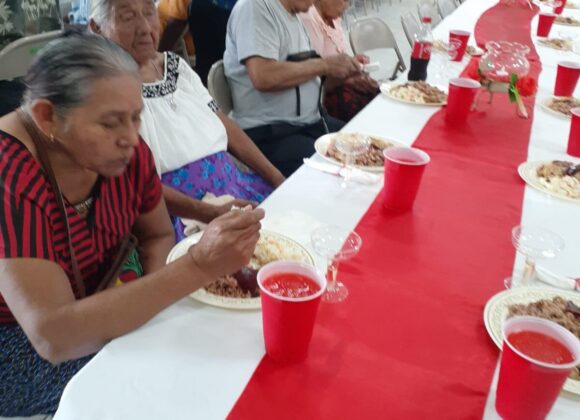 Guests enjoying a Christmas meal together at a community hall