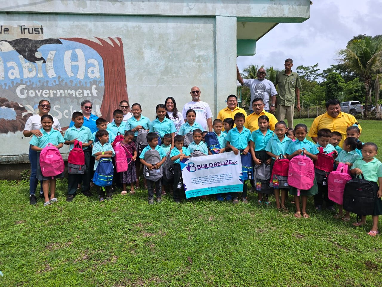 Pupils holding new Build Belize backpacks outside Habet Ha Government School